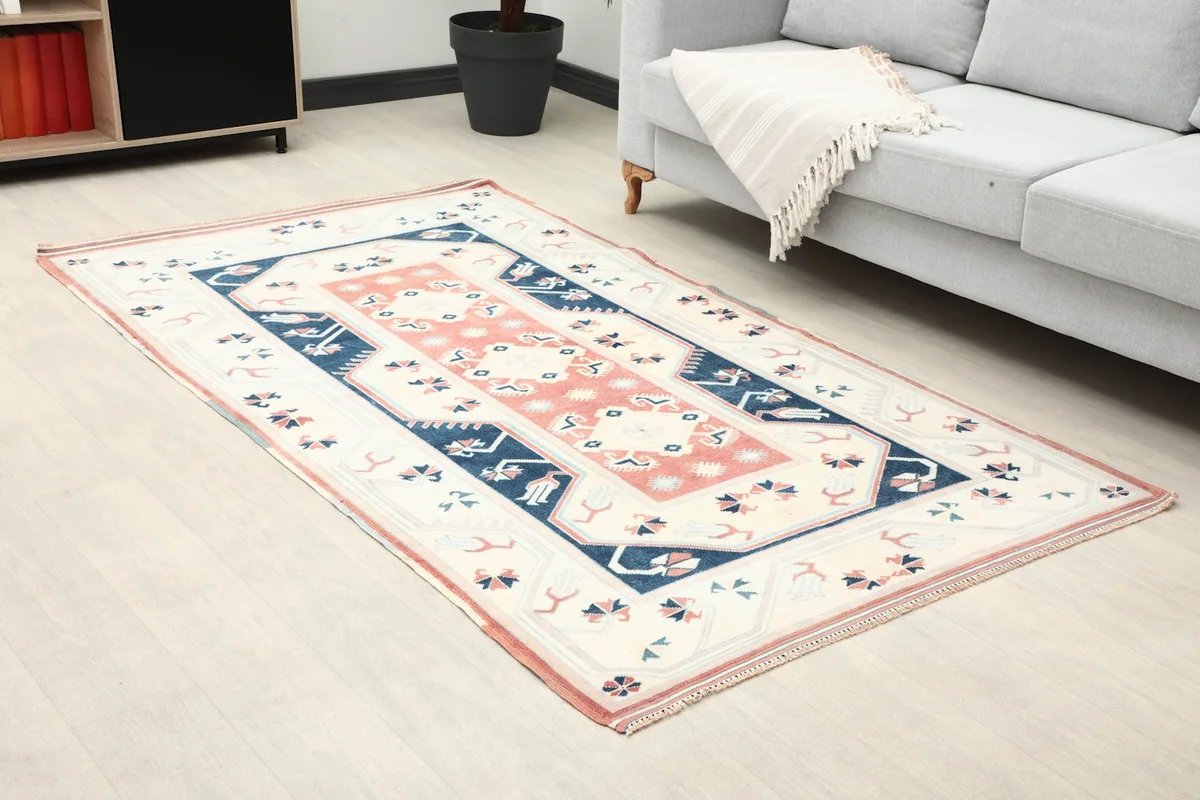 Angled view of the rug in a room, showing its placement near a sofa