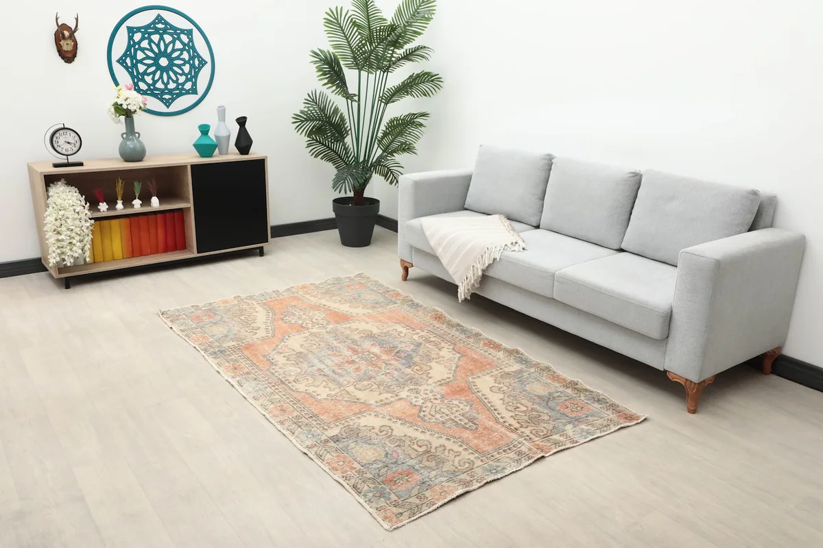 Rug placed in a modern living room setting with a gray sofa and wooden cabinet