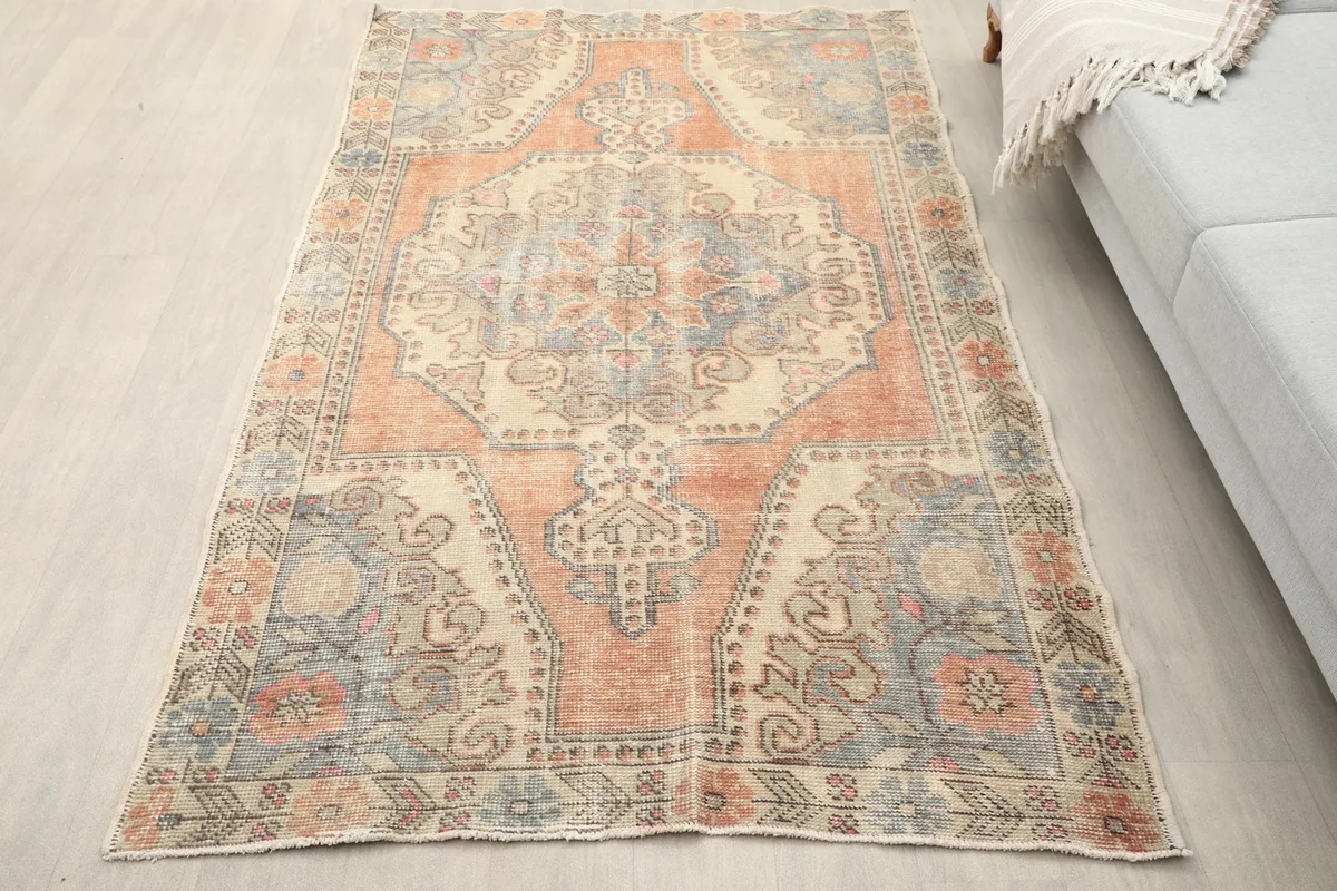 Overhead view of the rug on a light floor next to a sofa