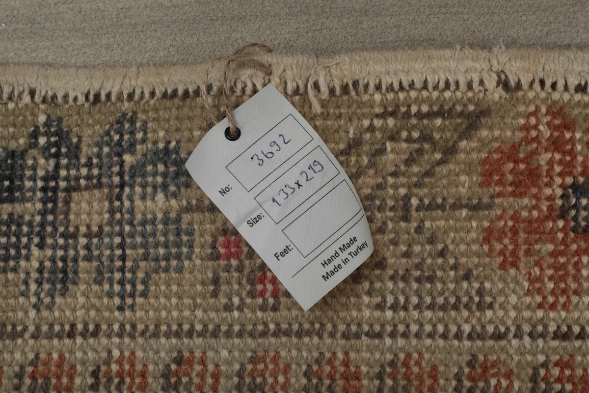 Close-up of the rug's tag, indicating its size and origin as handmade in Turkey