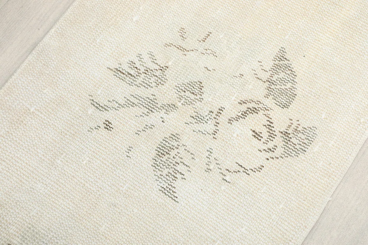 Close-up of a floral motif, revealing the hand-knotted wool pile and cotton foundation.