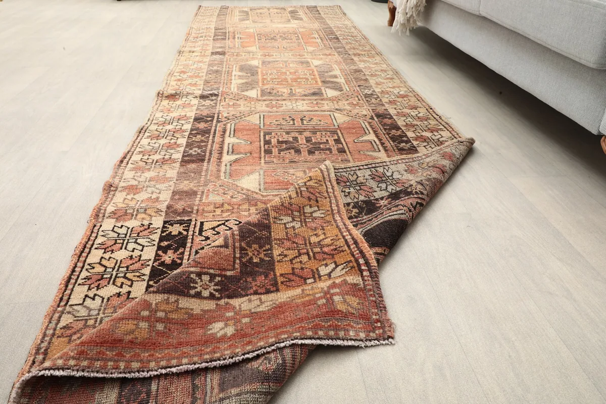 Runner partially folded, showing the full length and the reverse side of the rug
