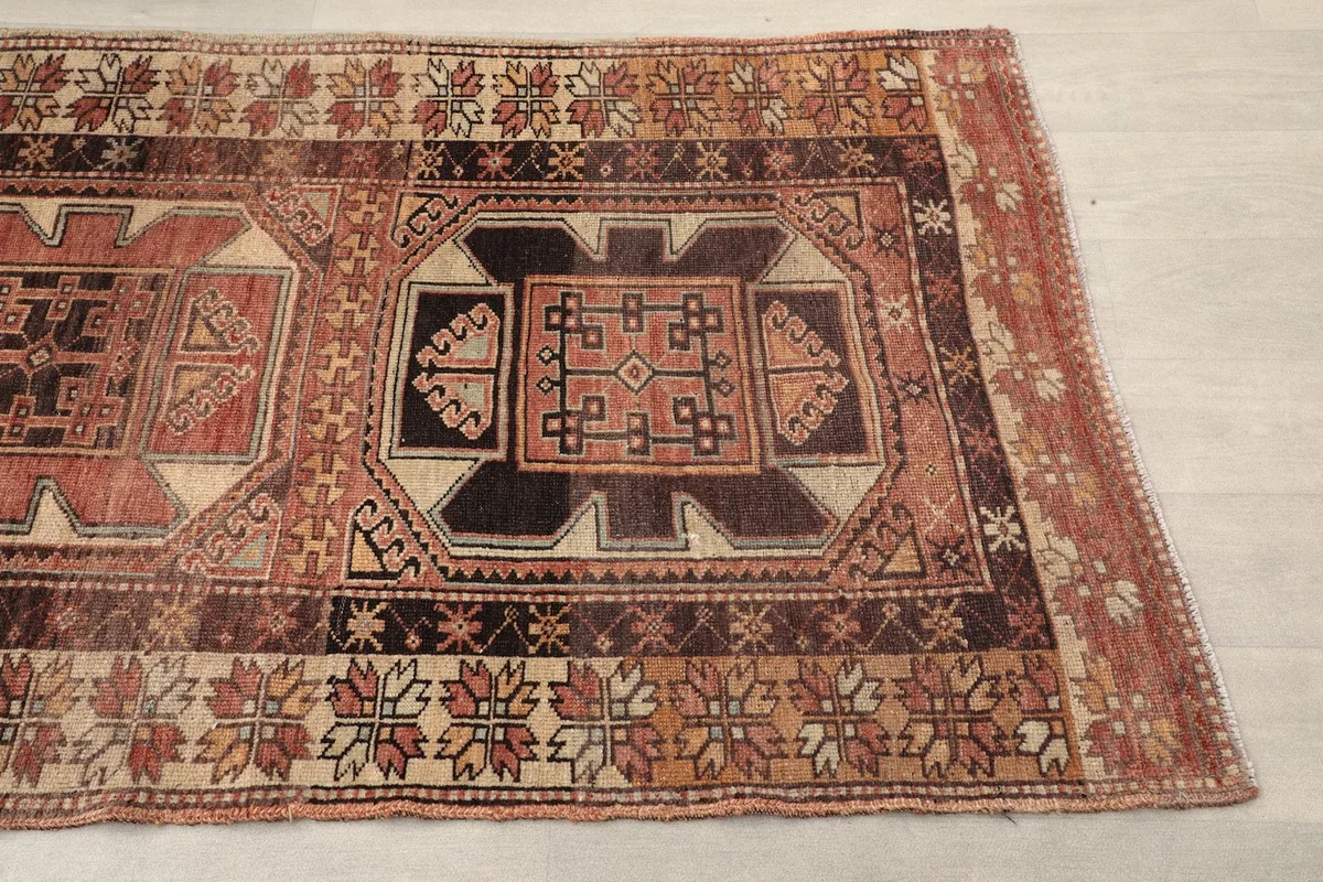 Close-up of a geometric panel on the runner, showing rust, brown, and beige colors