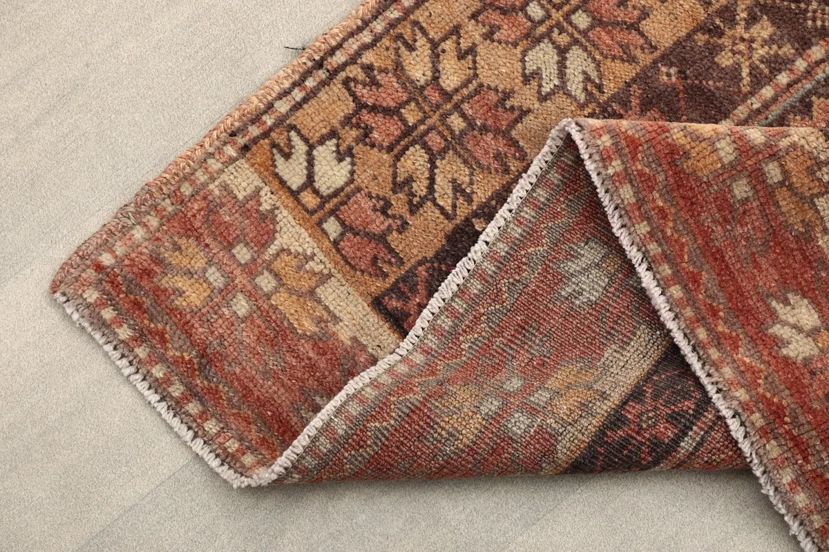 Folded corner of the runner showing the back of the rug and the professional cleaning