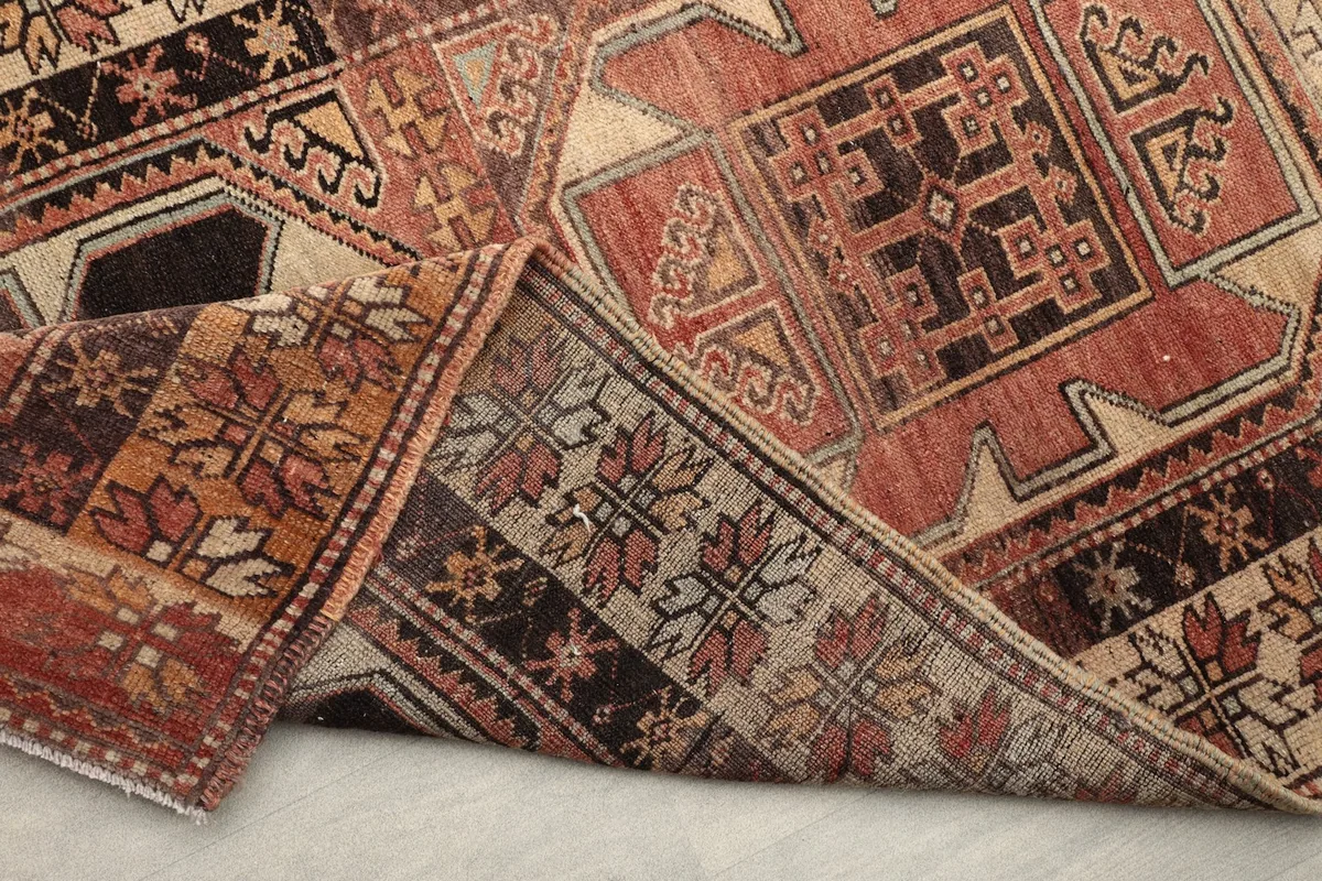 Side view of the runner with a corner folded, revealing the wool pile and cotton foundation