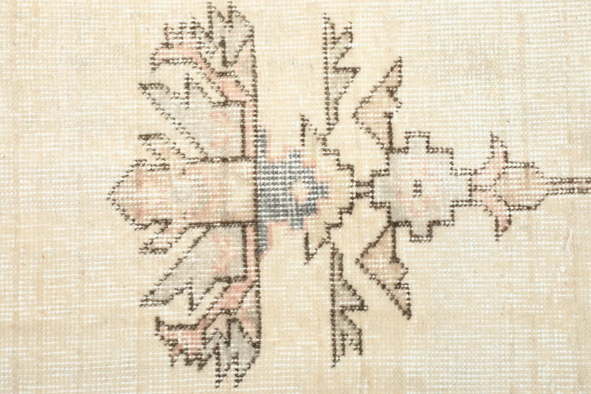 Close-up of a geometric motif within the rug's pattern, showing wool texture and colors.