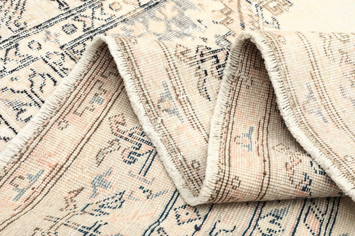 Close-up of the low wool pile and the intricate knotting visible in the folded section.
