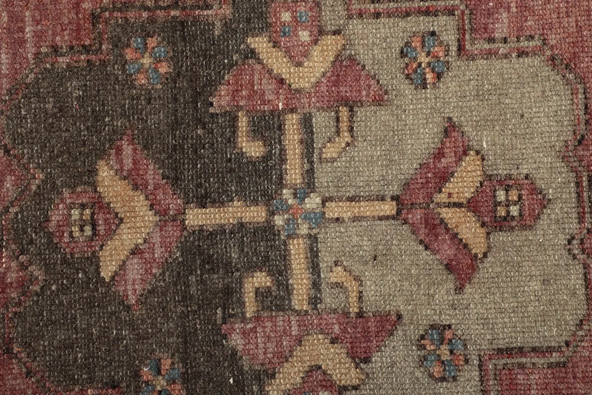 Intricate detail of a tribal motif within the central design, showing various colors