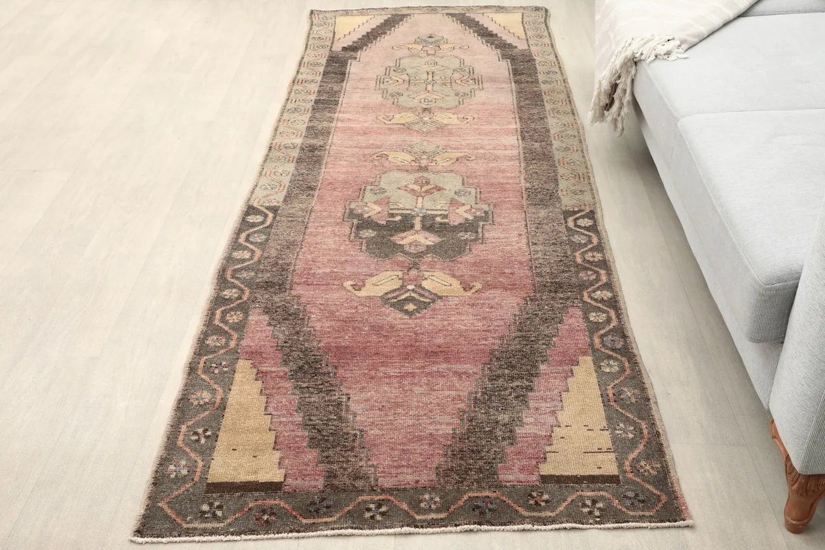 Overhead view of the vintage Anatolian runner rug in a room setting next to a sofa