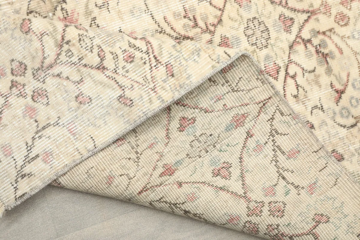 View of the back of the hand-knotted wool rug, revealing the cotton foundation and tight weave.
