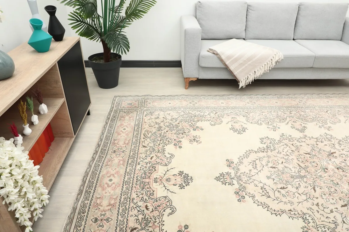 Angled view of the large vintage rug in a living room, showcasing its size and pattern