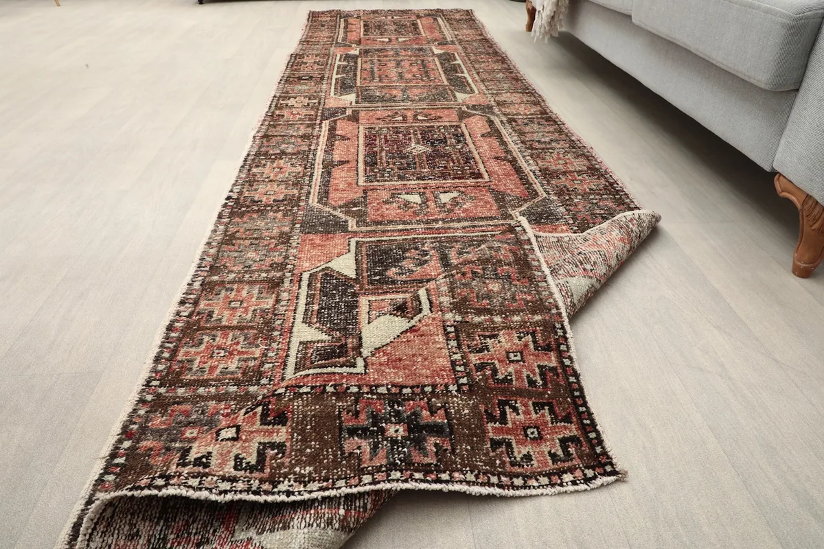 Angled view of the entire runner rug, partially folded, showcasing its length