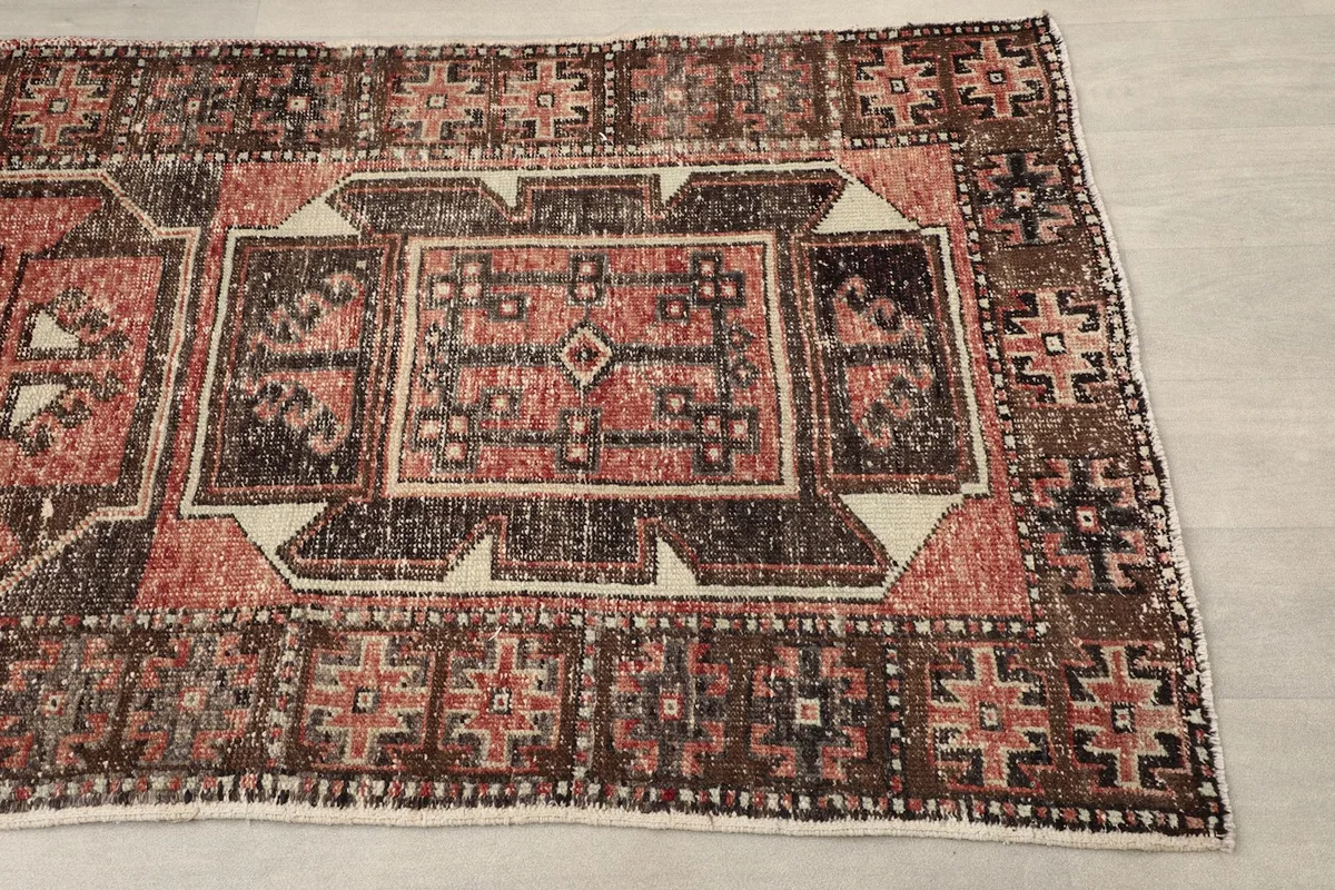 Close-up of the rug's geometric pattern and colors from one end