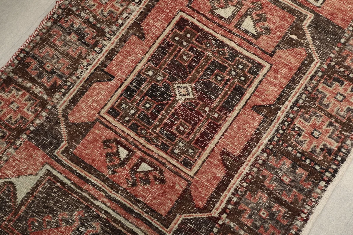 Detailed view of the central rust and brown geometric medallion