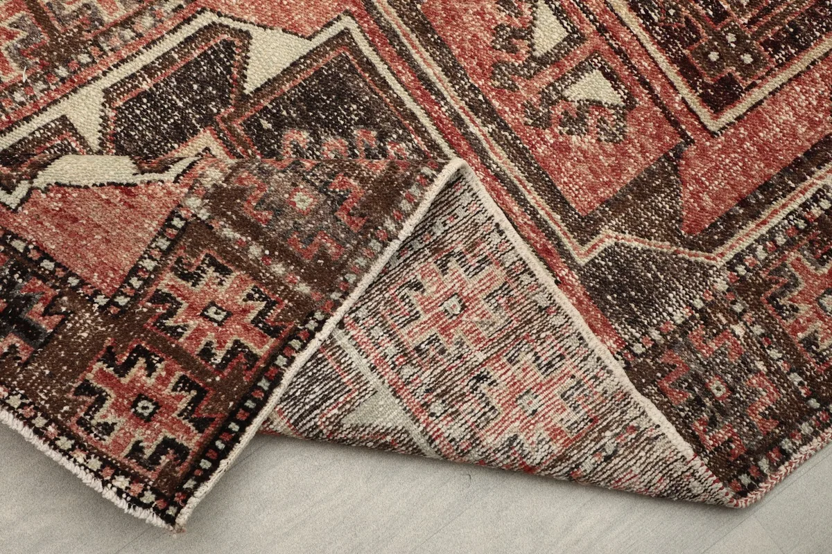 Close-up of the folded rug corner, highlighting the reverse side and edge