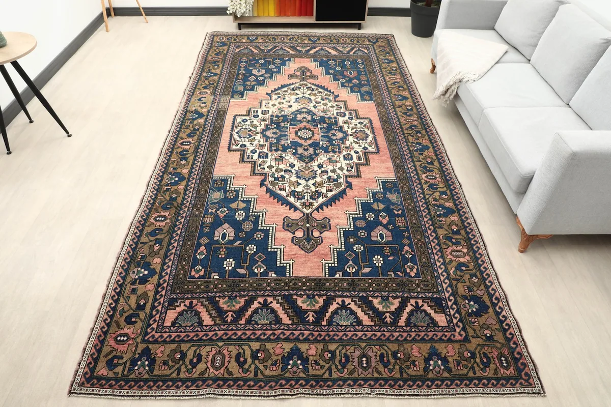 Vintage area rug in a living room setting with a light gray sofa and modern decor