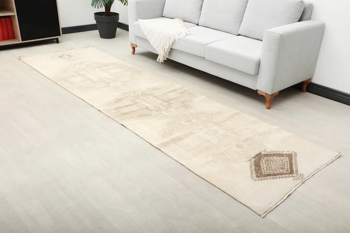 Angle view of the runner rug in a room, showing its texture and color variation under natural light.