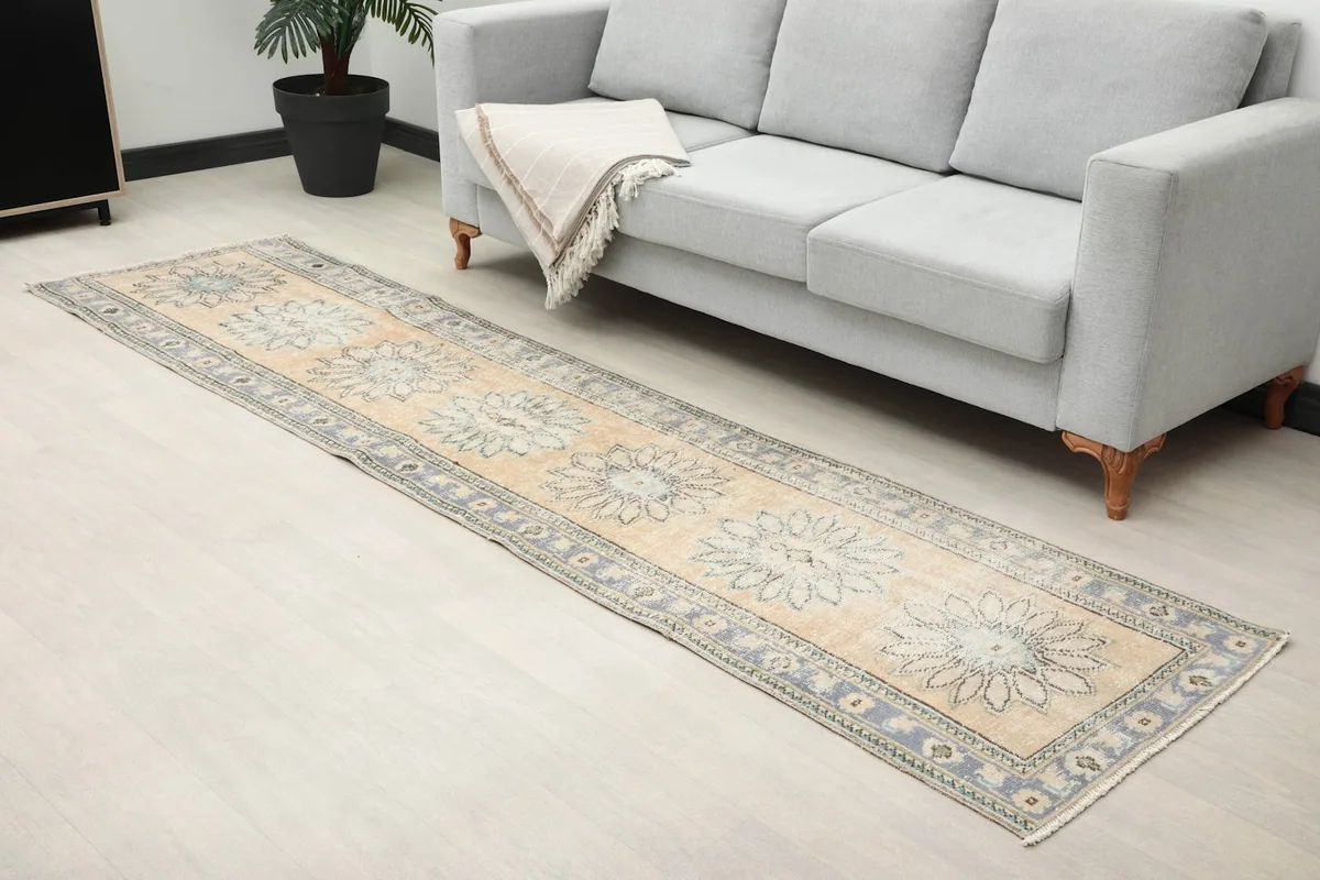 Angled view of the floral runner rug in a room, showcasing its placement and design near a sofa.