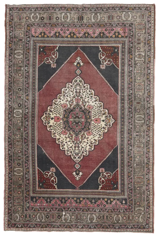 Full overhead view of the vintage Anatolian rug with rust, rose, gray, and black colors