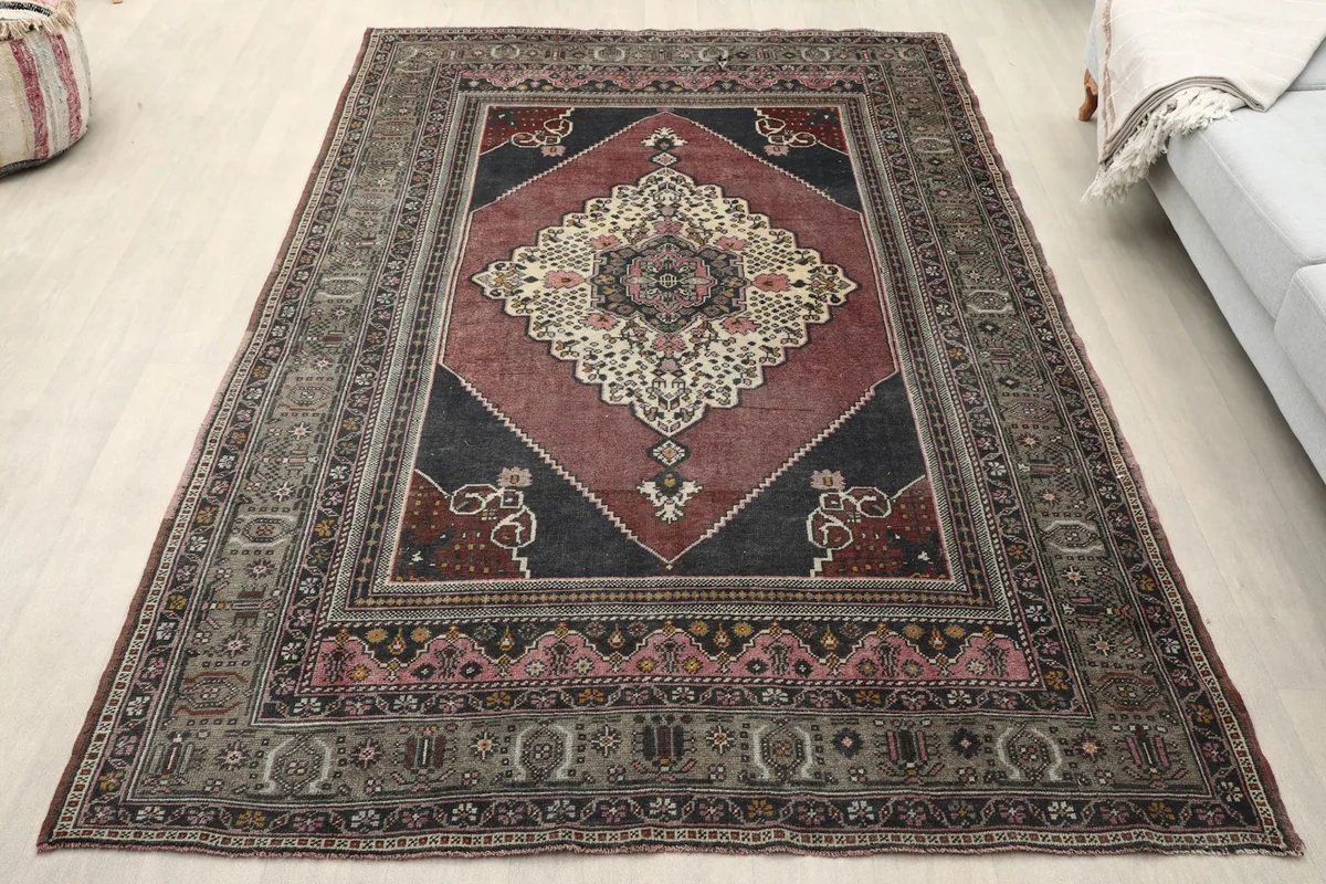 Vintage Anatolian rug displayed in a room setting from an angle, showing its full size