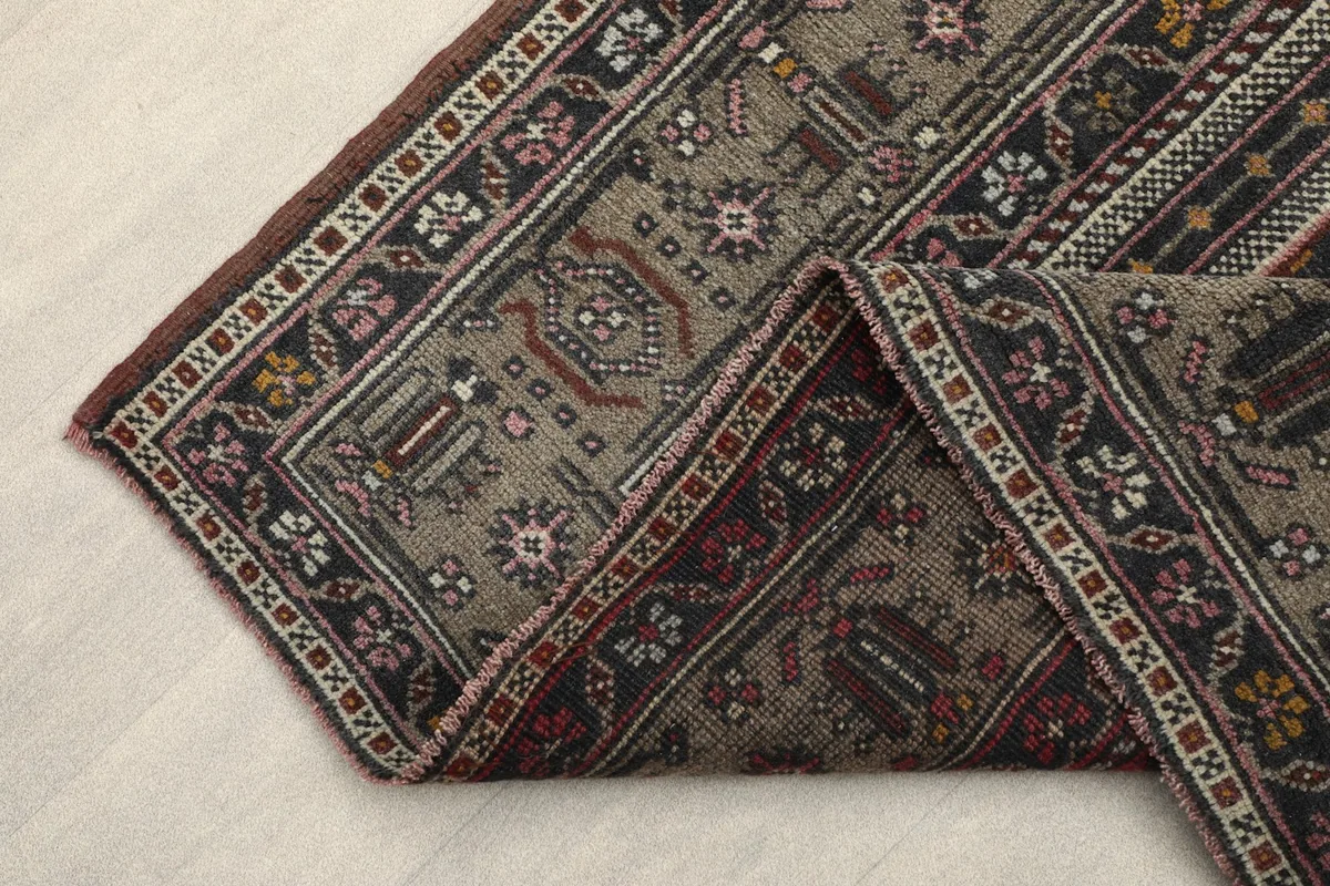 Underside of the rug, showing the tightly woven cotton foundation and hand-knotted construction