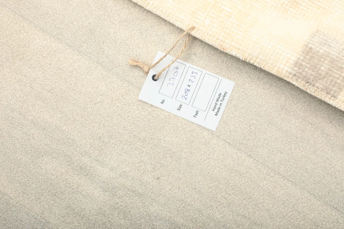 Tag attached to the rug, indicating its size and origin as vintage Anatolian