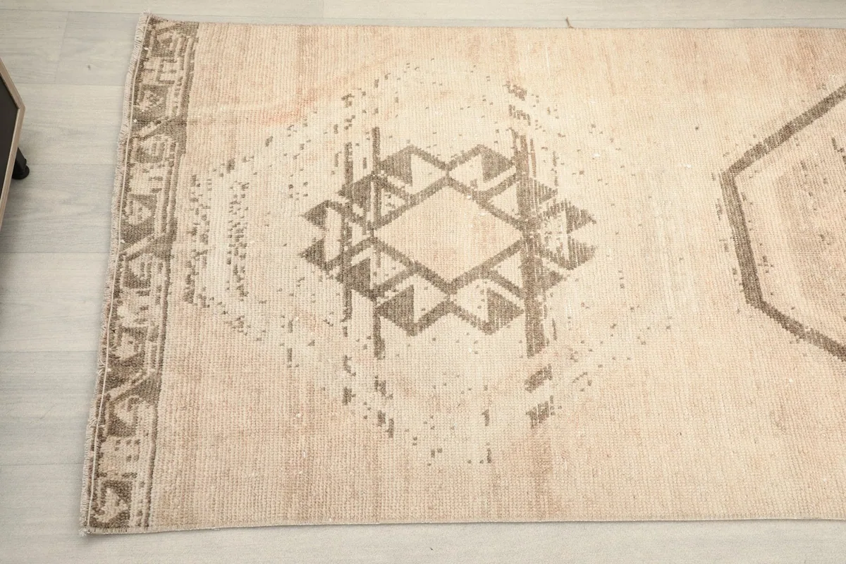 Detailed view of the distressed geometric pattern and side border on the runner rug.