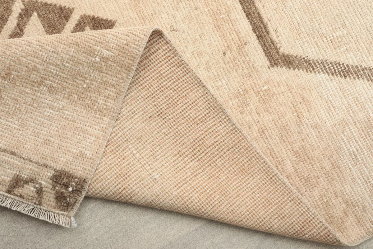 Underside of the runner rug, revealing the tightly woven cotton foundation.