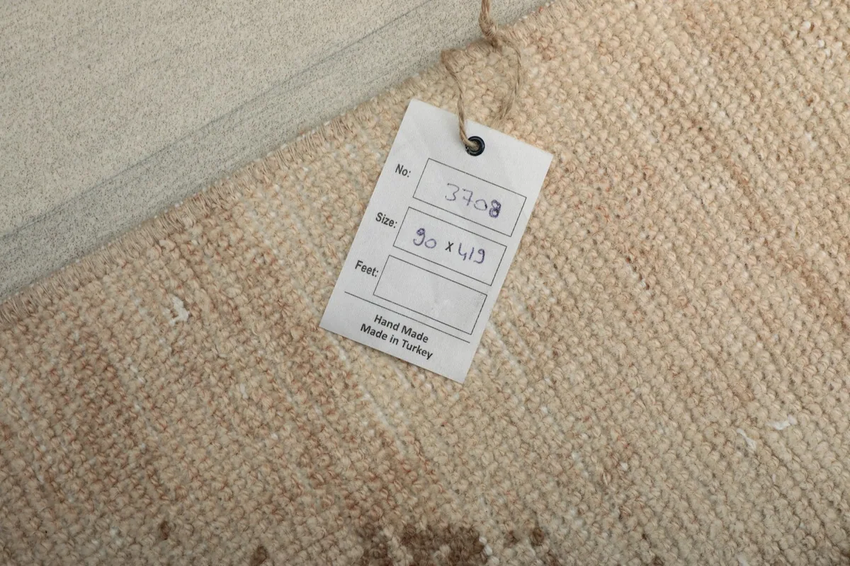 Close-up of the product tag indicating 'Hand made in Turkey' and rug dimensions.