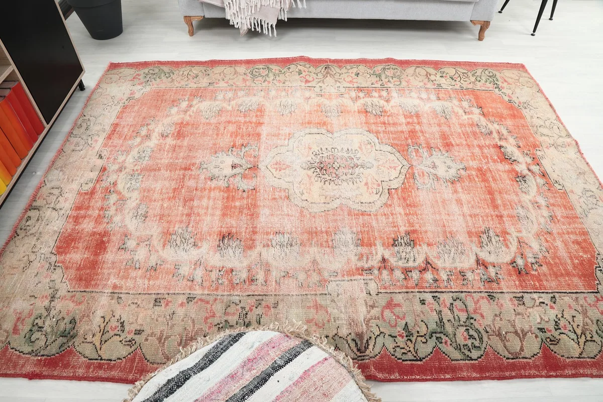 Another wide angle of the rust rug, demonstrating its impact as a central decor piece.