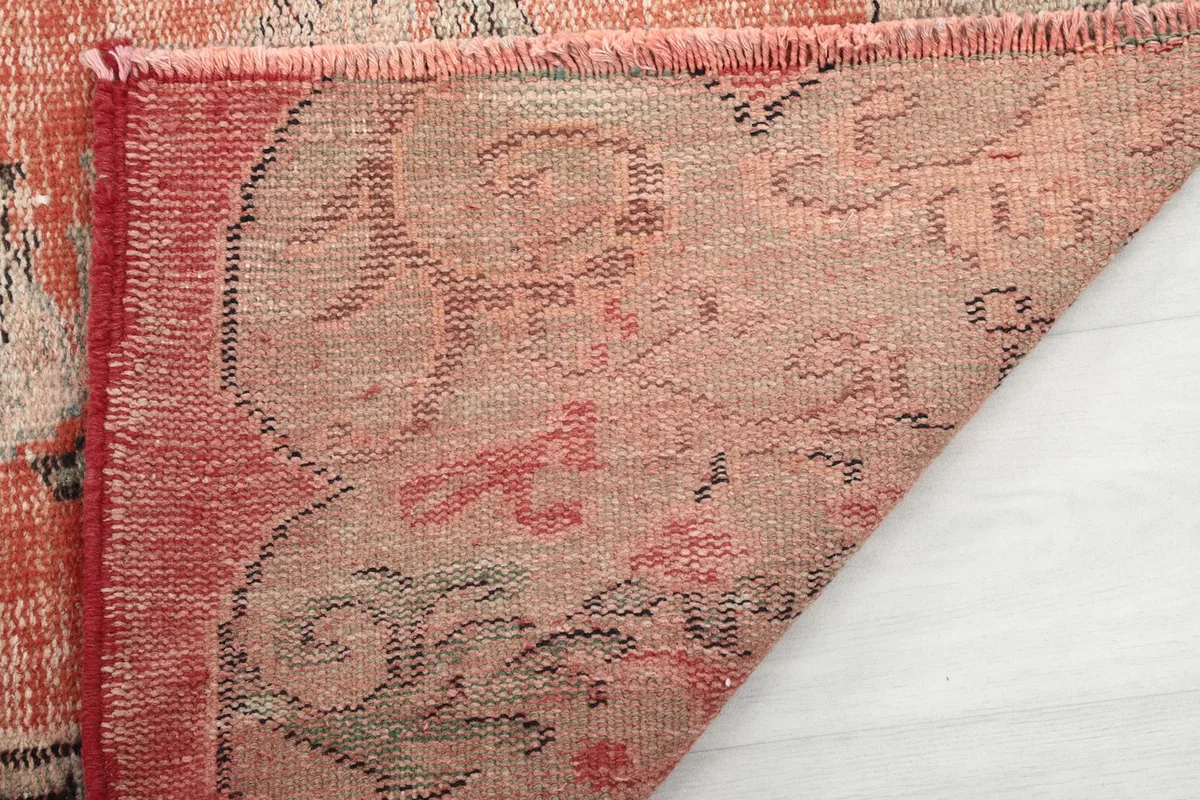 Close-up of the back of the rug, showing the cotton foundation and hand-knotted construction.