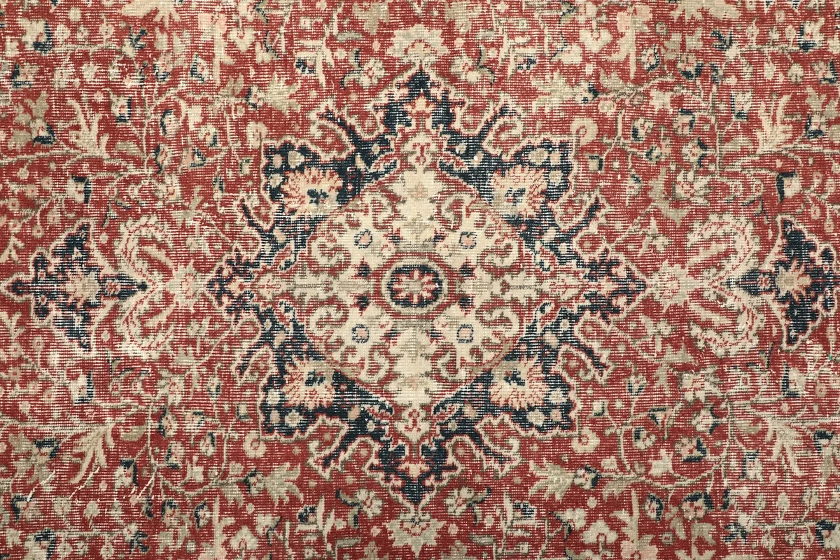 Close-up of the central red medallion and floral patterns