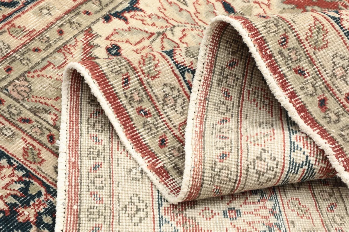 Close-up of the rug's edge and texture, showing a folded section