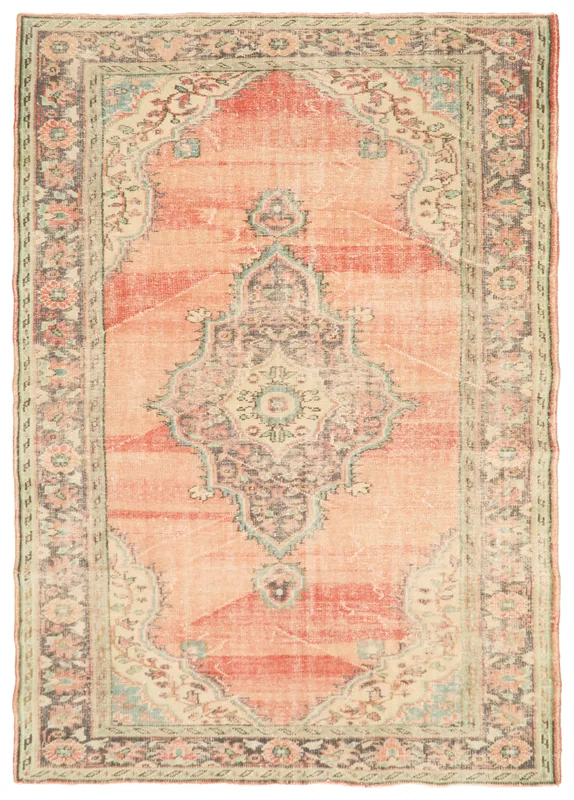 Full overhead view of the vintage orange Anatolian wool rug with a central medallion.