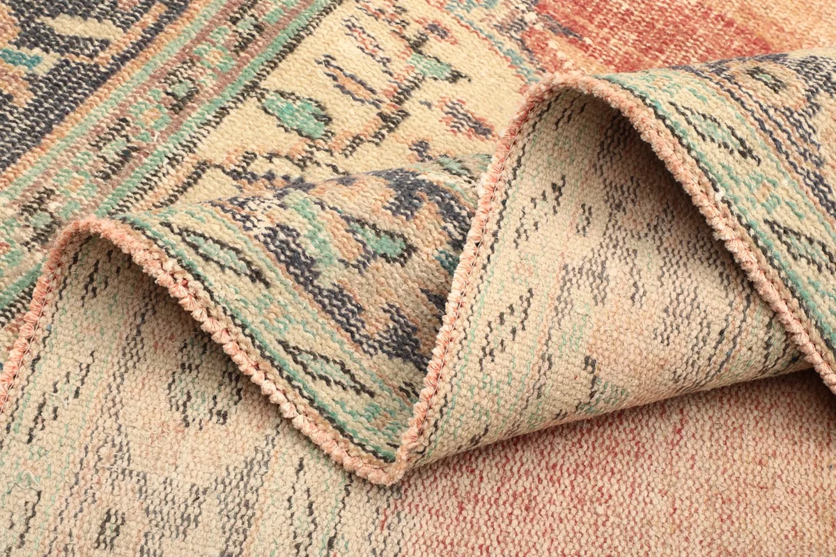 Close-up of a folded section of the rug, showing the density of the wool pile and backing.
