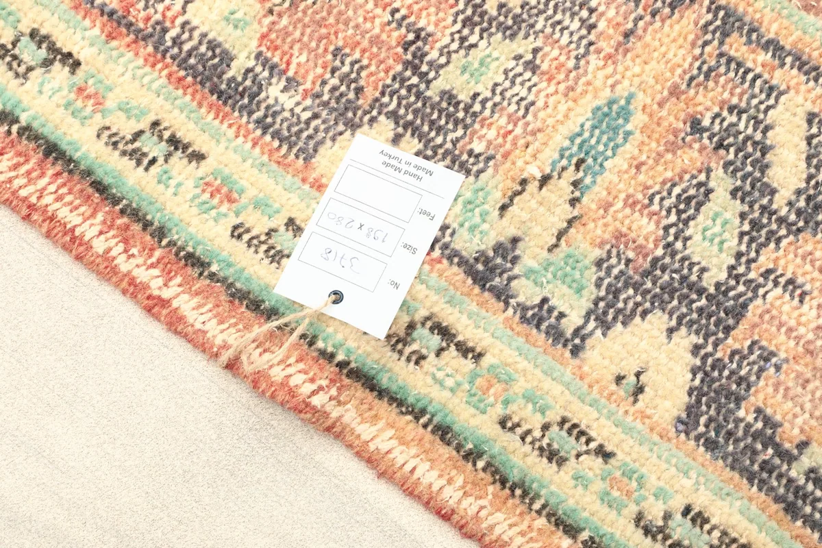 Rug tag attached to the corner of the rug, showing product information.