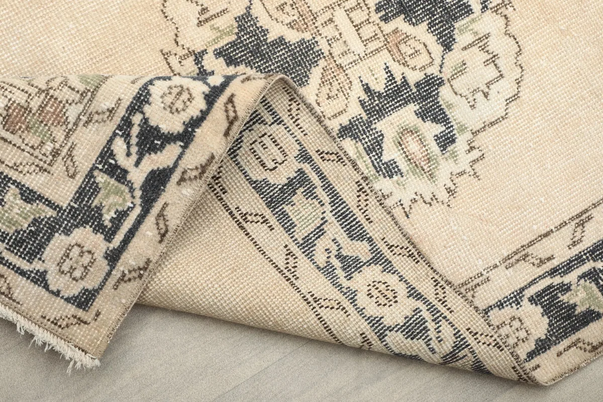 Another folded view, emphasizing the rug's flexibility and the detailed patterns of the pile.