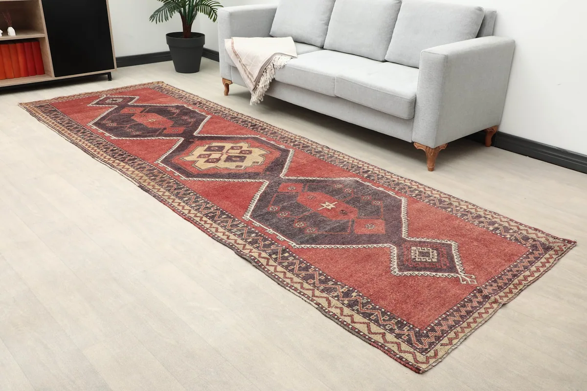 Runner rug with geometric motifs in a room, offering a perspective of its design and color palette.