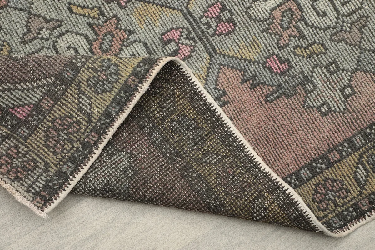 Folded corner displaying the back of the runner, revealing the tight knotting and foundation details.