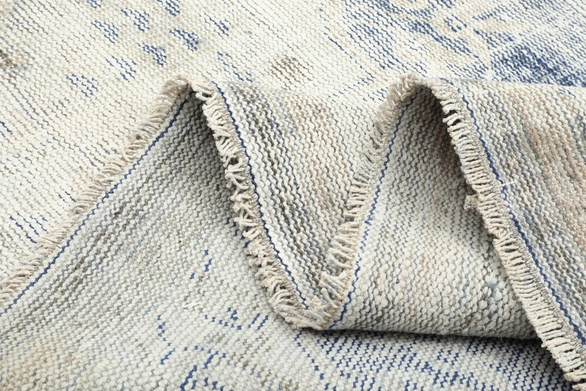 Close-up of the back of the rug, showing the tight hand-knotted weave and cotton foundation.