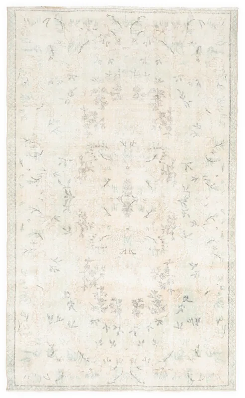 Full top view of the 5x9 ivory floral vintage Anatolian area rug on a white background