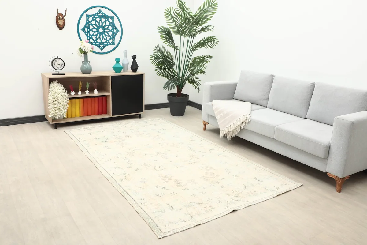 Overhead view of the ivory floral rug in a room with modern furniture and decor