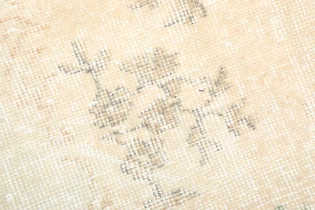 Texture close-up of the low wool pile, showing the hand-knotted construction and color variations