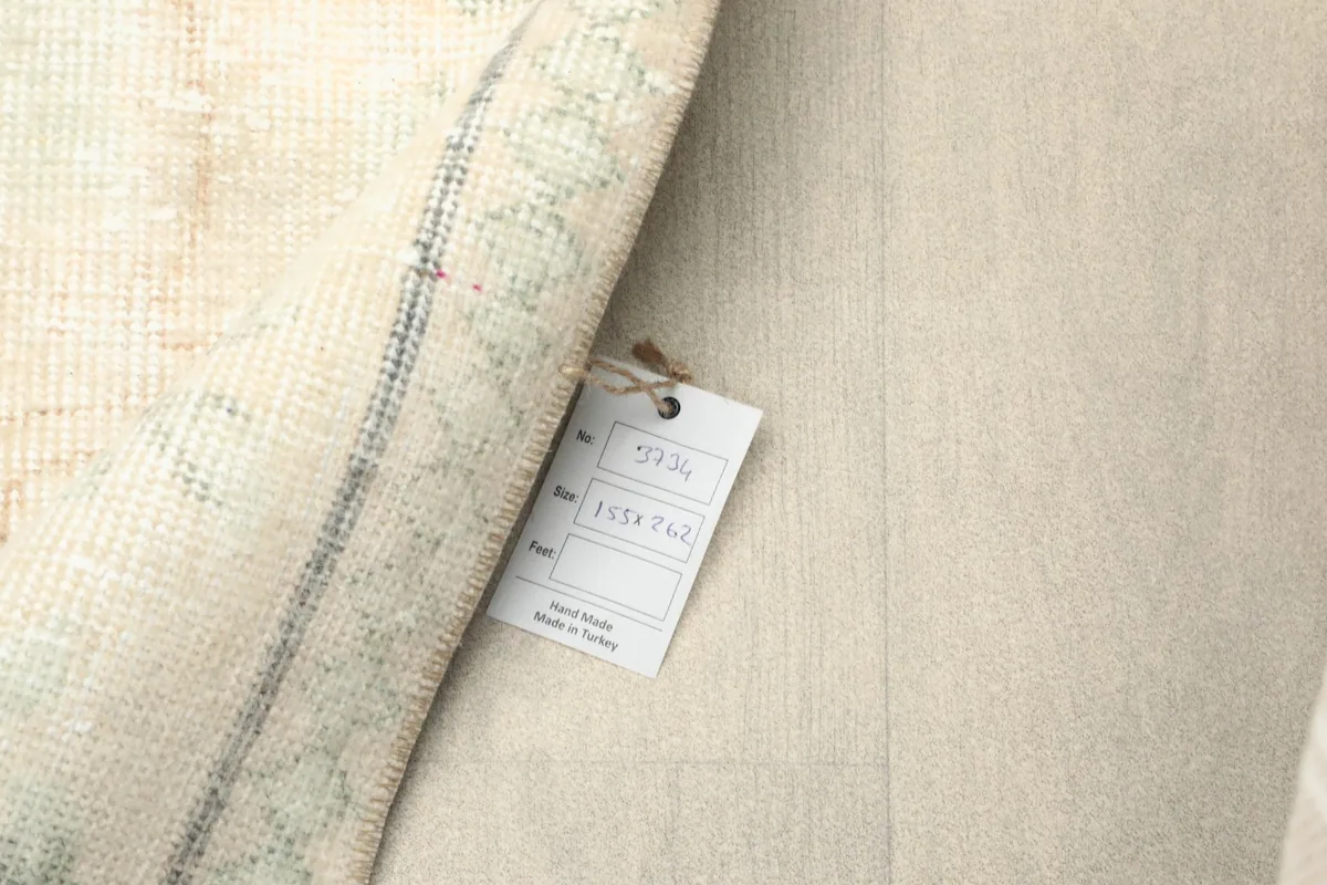 Backside of the rug with the product tag, showing the hand-knotted weave