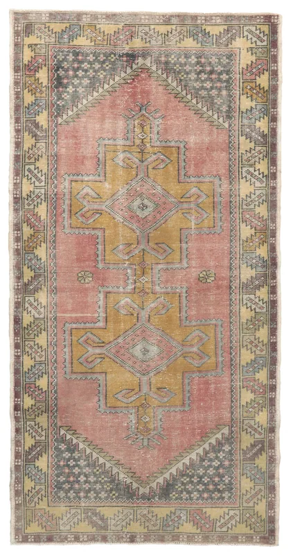 Full overhead view of the 4x8 vintage Anatolian rug with rose and gold geometric patterns.
