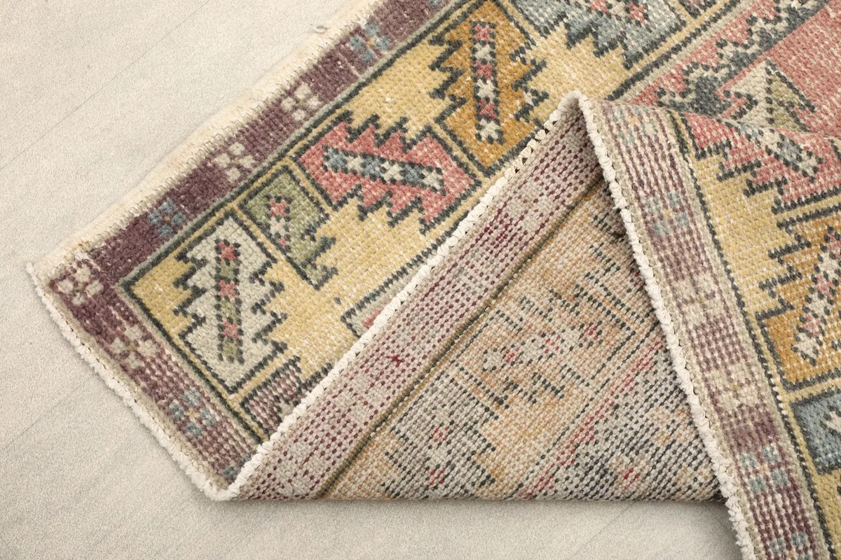 View of the rug's reverse side, showing the hand-knotted cotton foundation.