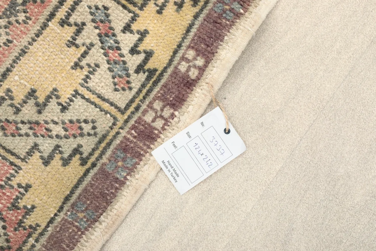 Corner of the rug with its product tag, displaying dimensions and origin.