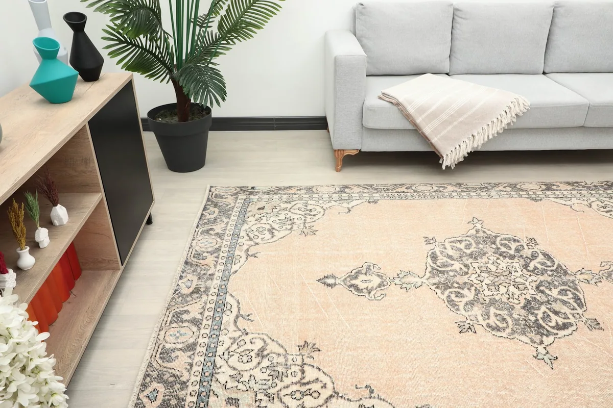 Angle view of the rug in a room, highlighting its placement next to a sofa
