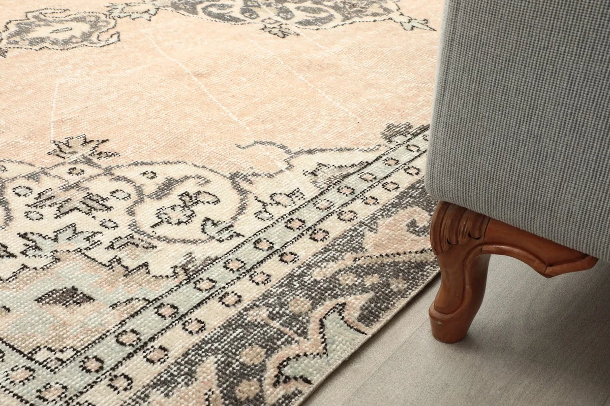 Rug placed under a sofa leg, illustrating its durability and fit in a room