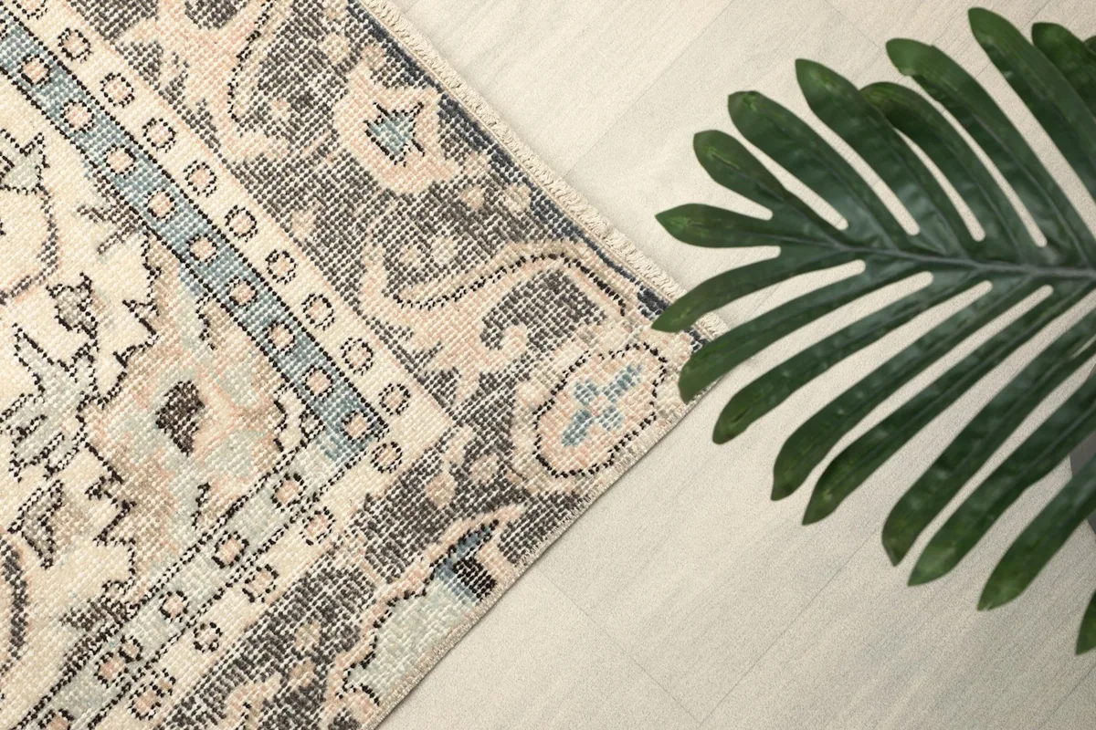 Intricate border detail with subtle blue accents and charcoal patterns
